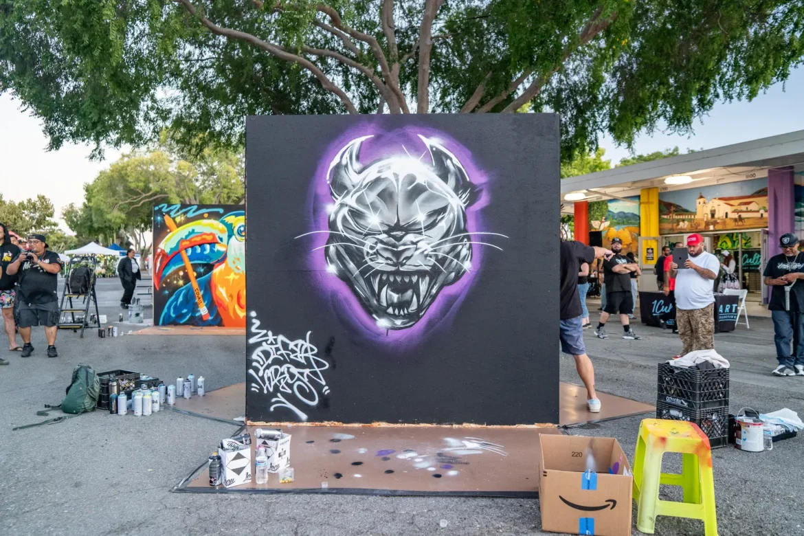 A purple tiger mural glows against its black background.