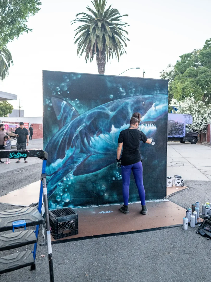 A breaking wave mural painted in blues and whites.