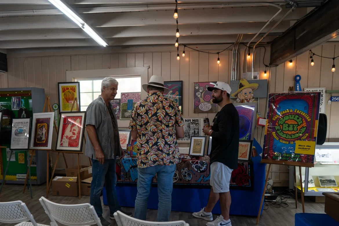 Visitors browse the framed works in the fine arts building.