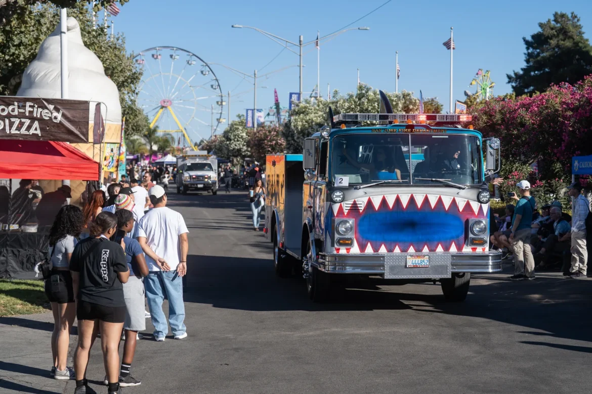 A painted fire truck draws a crowd along the midway.