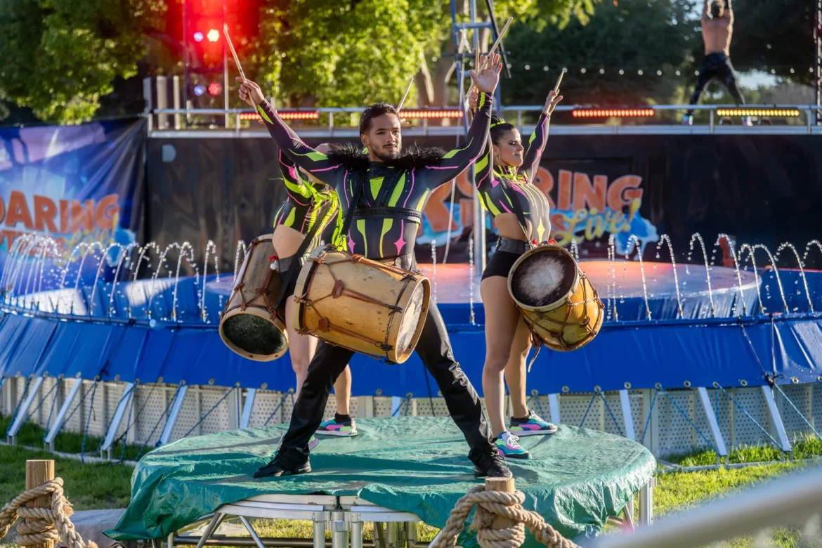 A performer works the crowd at the water stunt show.