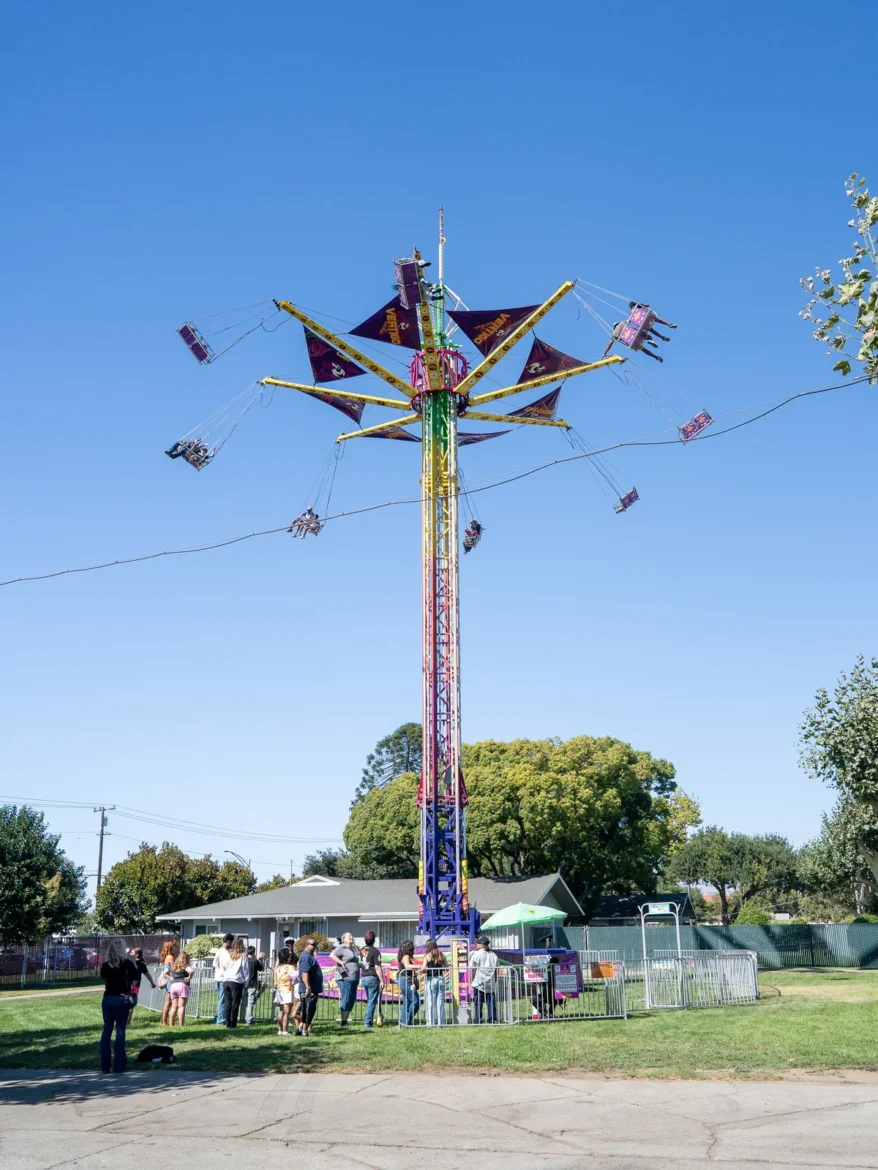 The swing ride turns against the evening sky.