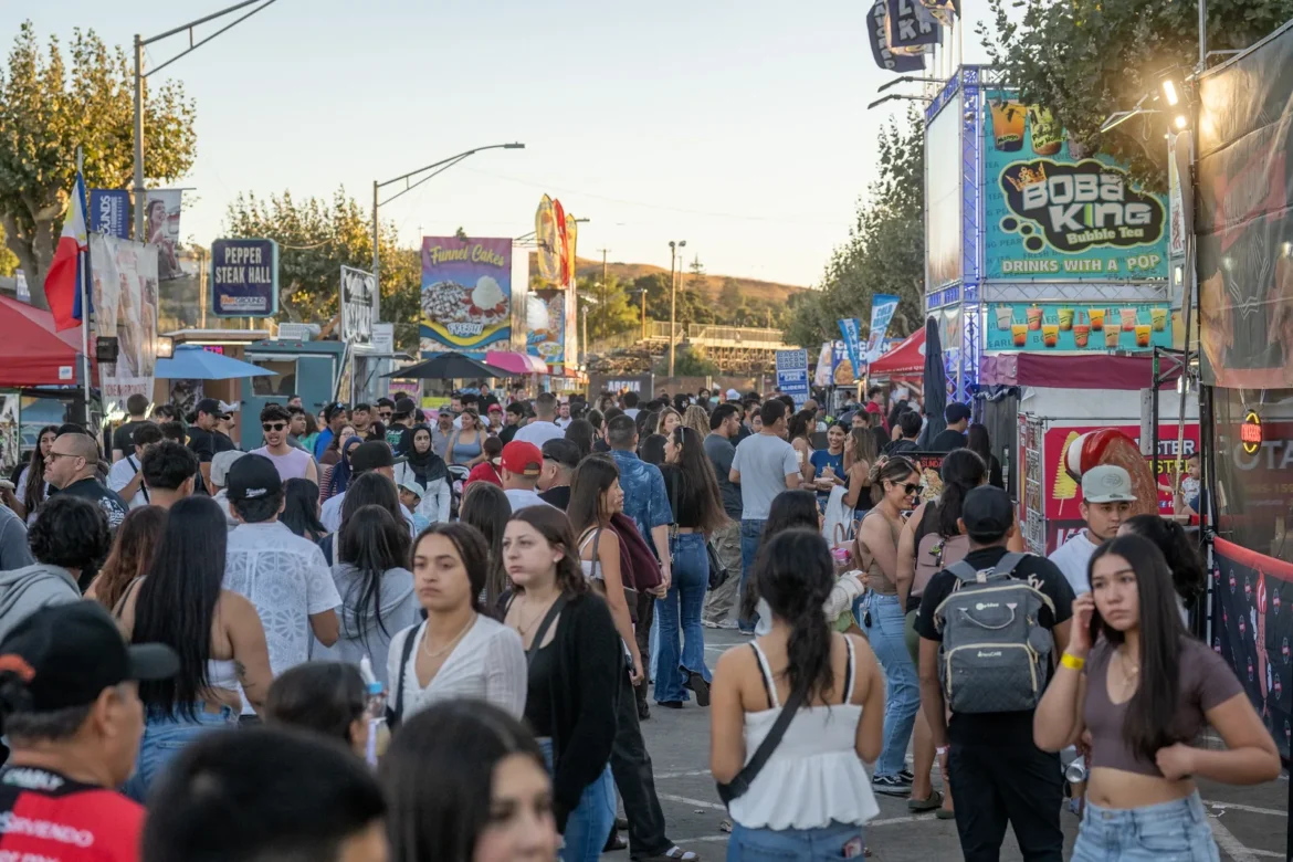 The midway fills with people as the lights come on.